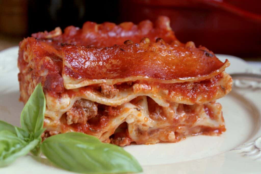 lasagna on a plate with basil