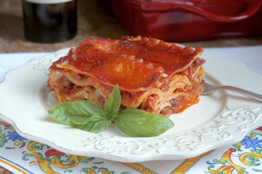 lasagna on a plate with an Italian napkin using a canned tomato recipe