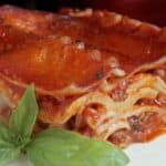 lasagna on a plate with an Italian napkin