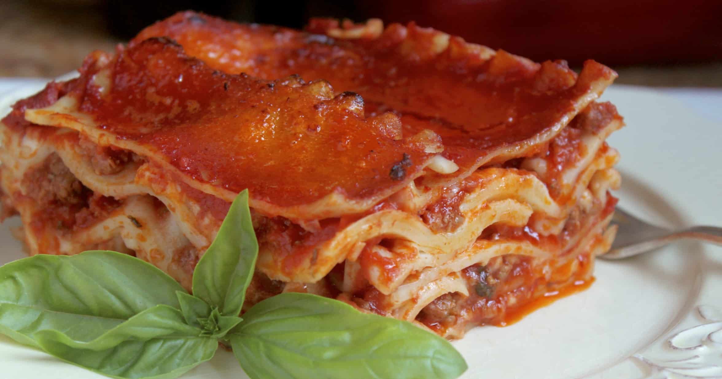 lasagna on a plate with an Italian napkin