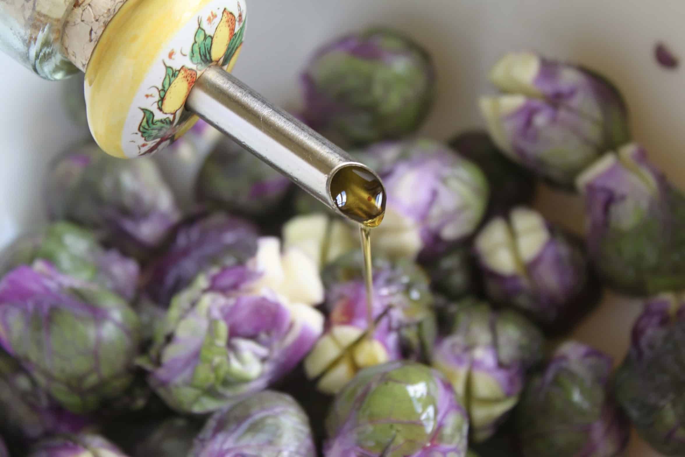 adding oil to purple vegetables