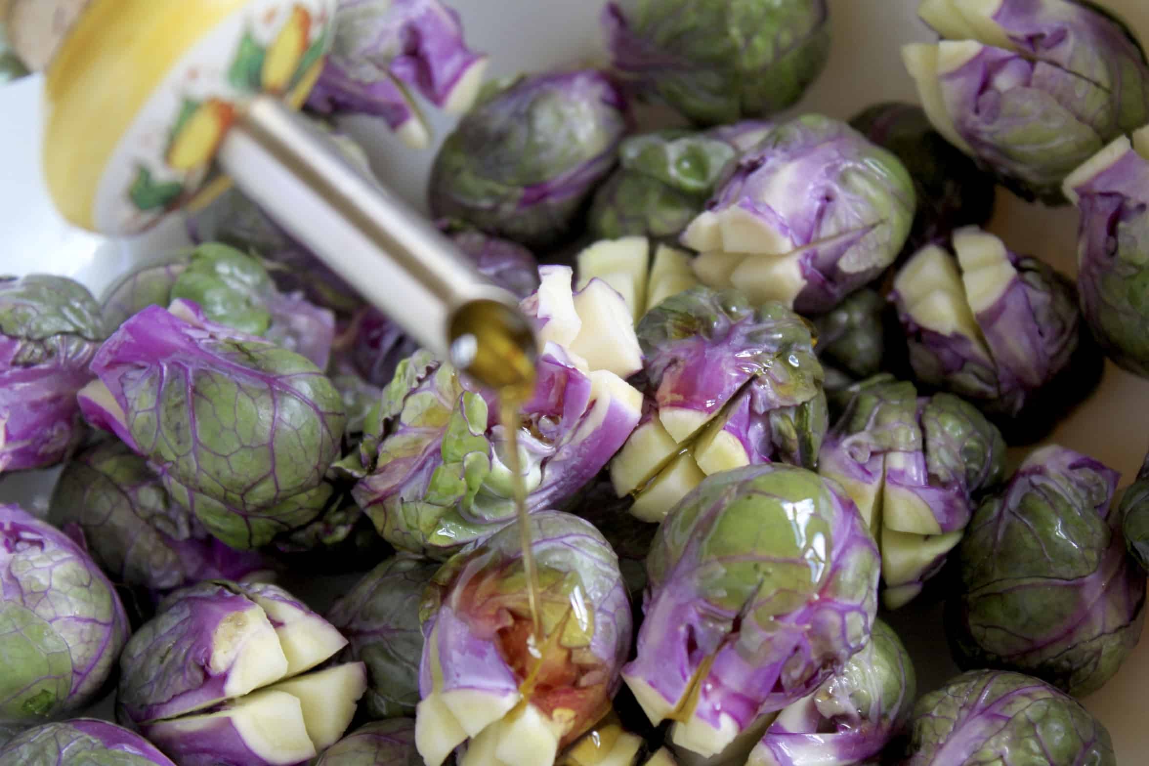 adding oil to Brussels sprouts 