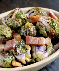 roasted brussel sprouts with pancetta in an oval dish