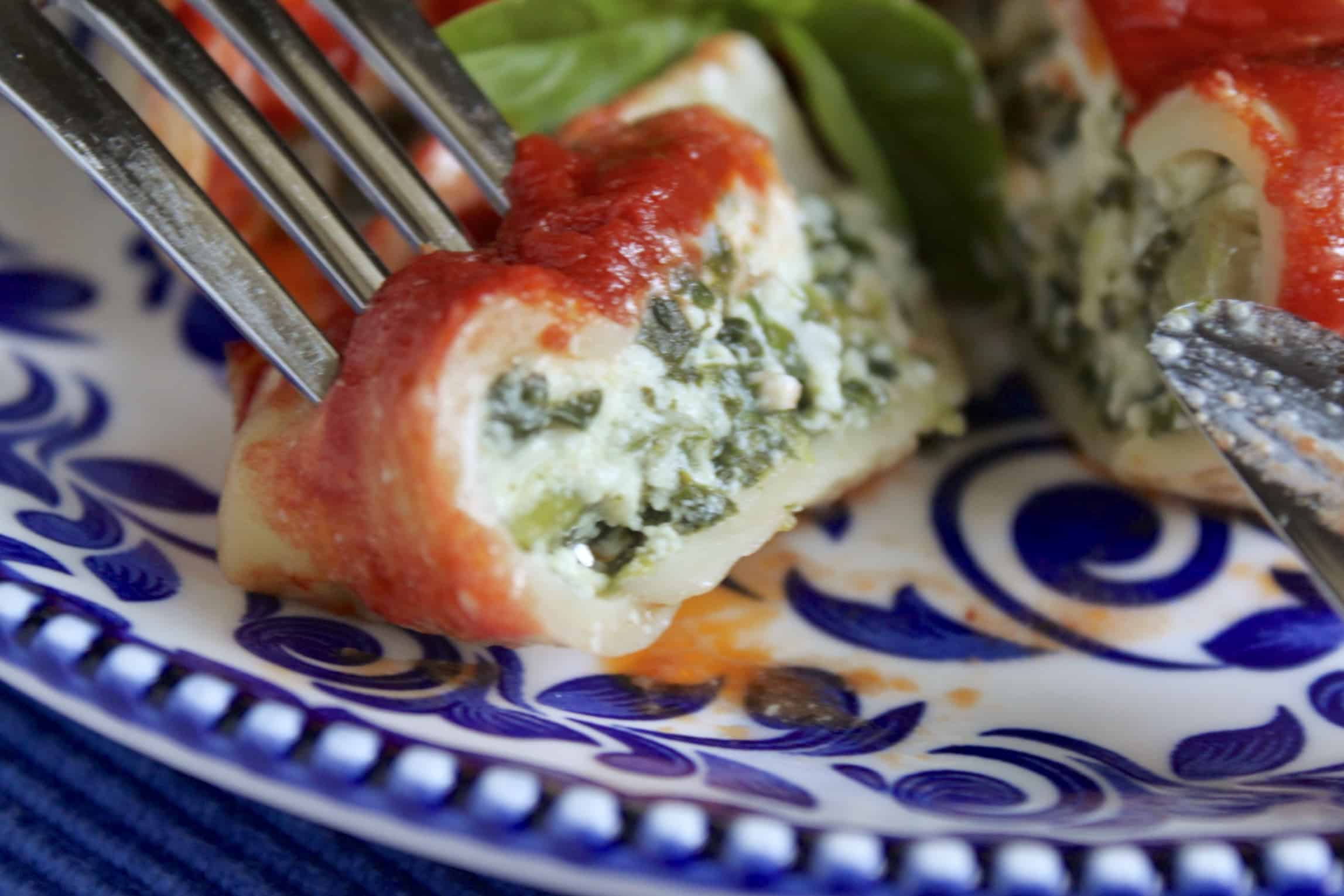 eating stuffed shells with spinach and ricotta