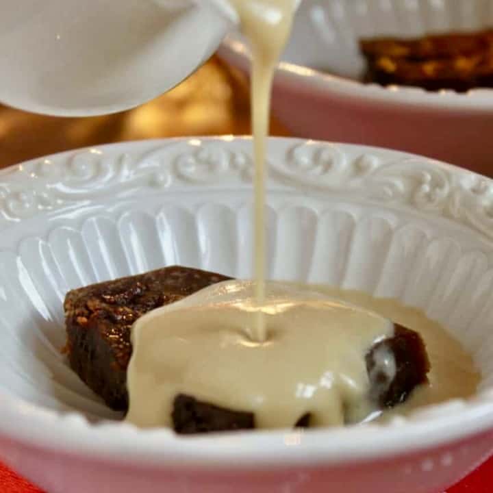 brandy sauce pouring on pudding slice