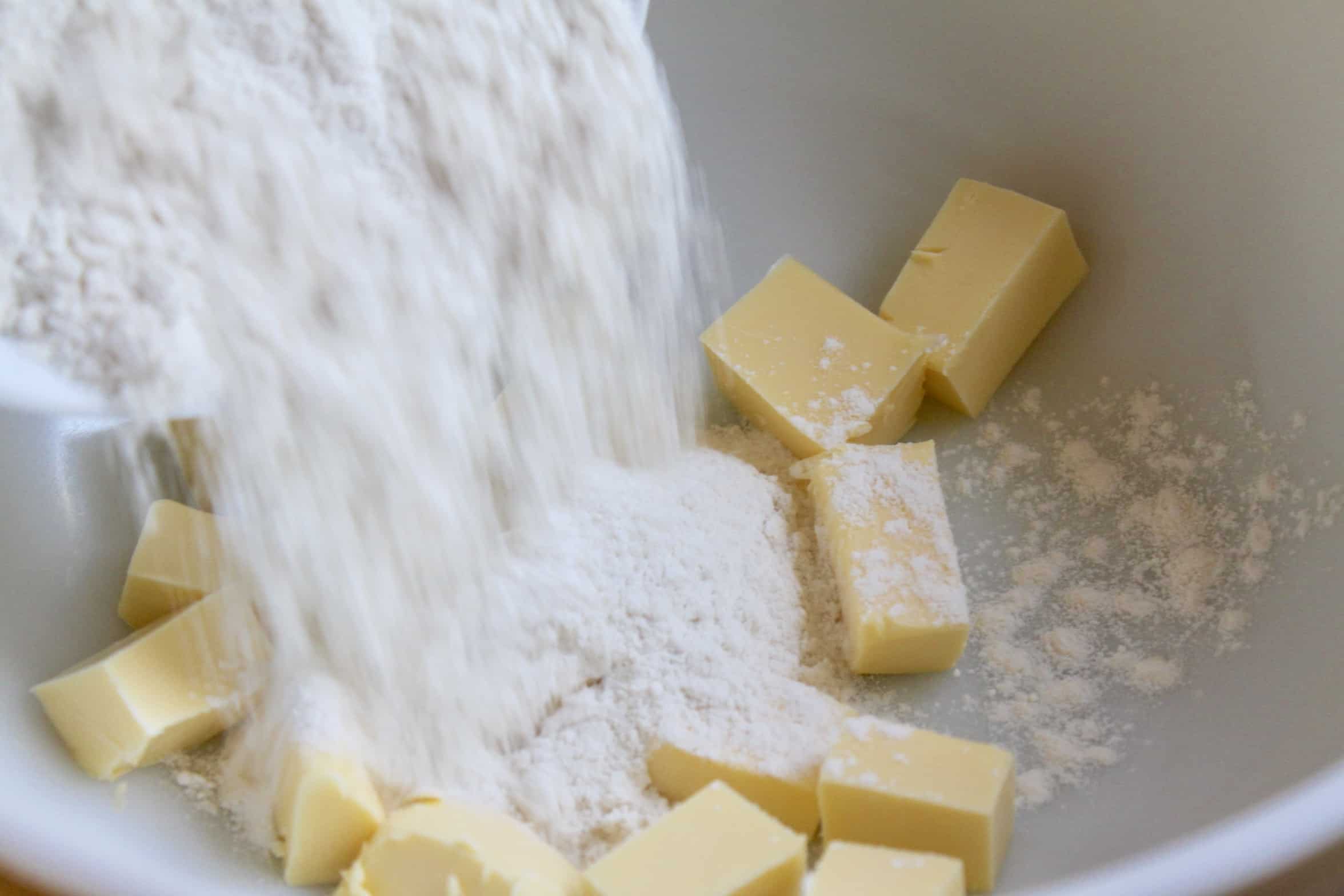 adding flour to butter