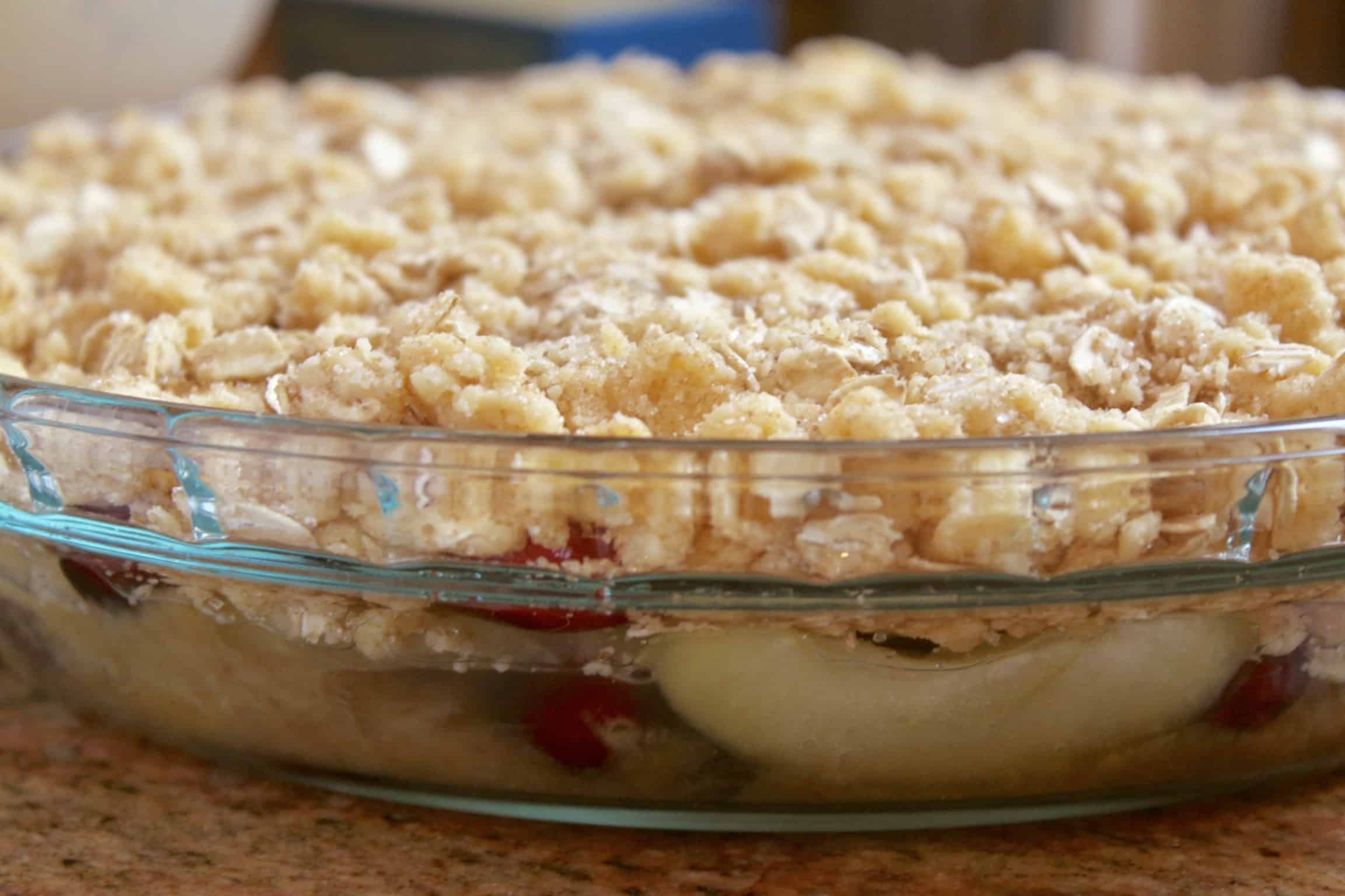 side view of apple cranberry crisp in pie dish