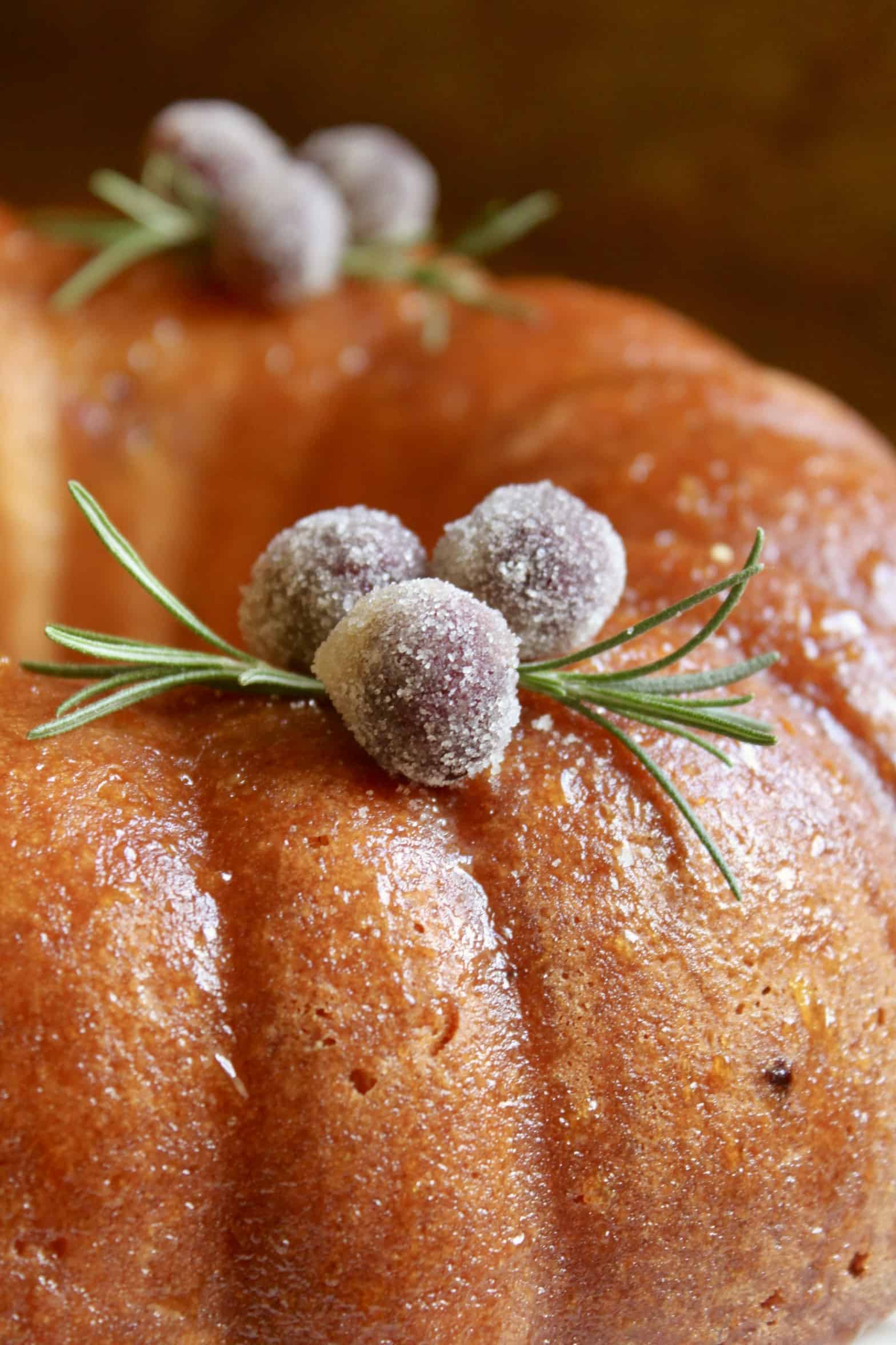 sugared cranberries and rosemary on cake