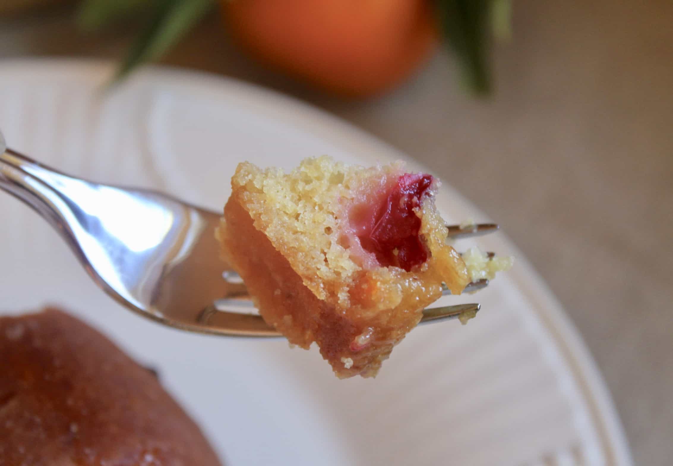 bite of orange cranberry cake on fork