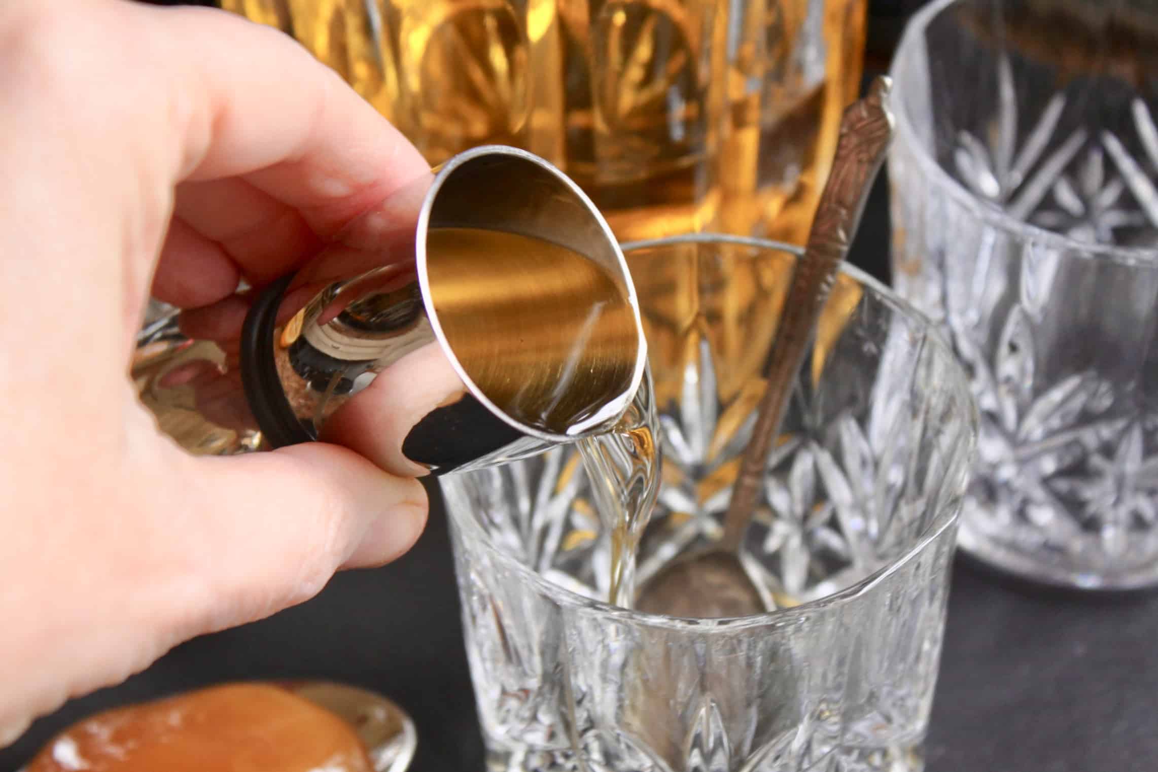 pouring whisky into crystal glass
