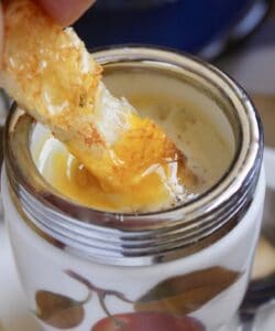 dipping toast into a coddled egg