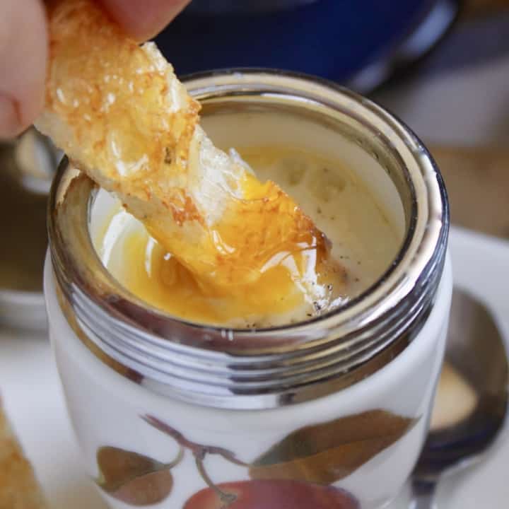 dipping toast into a coddled egg