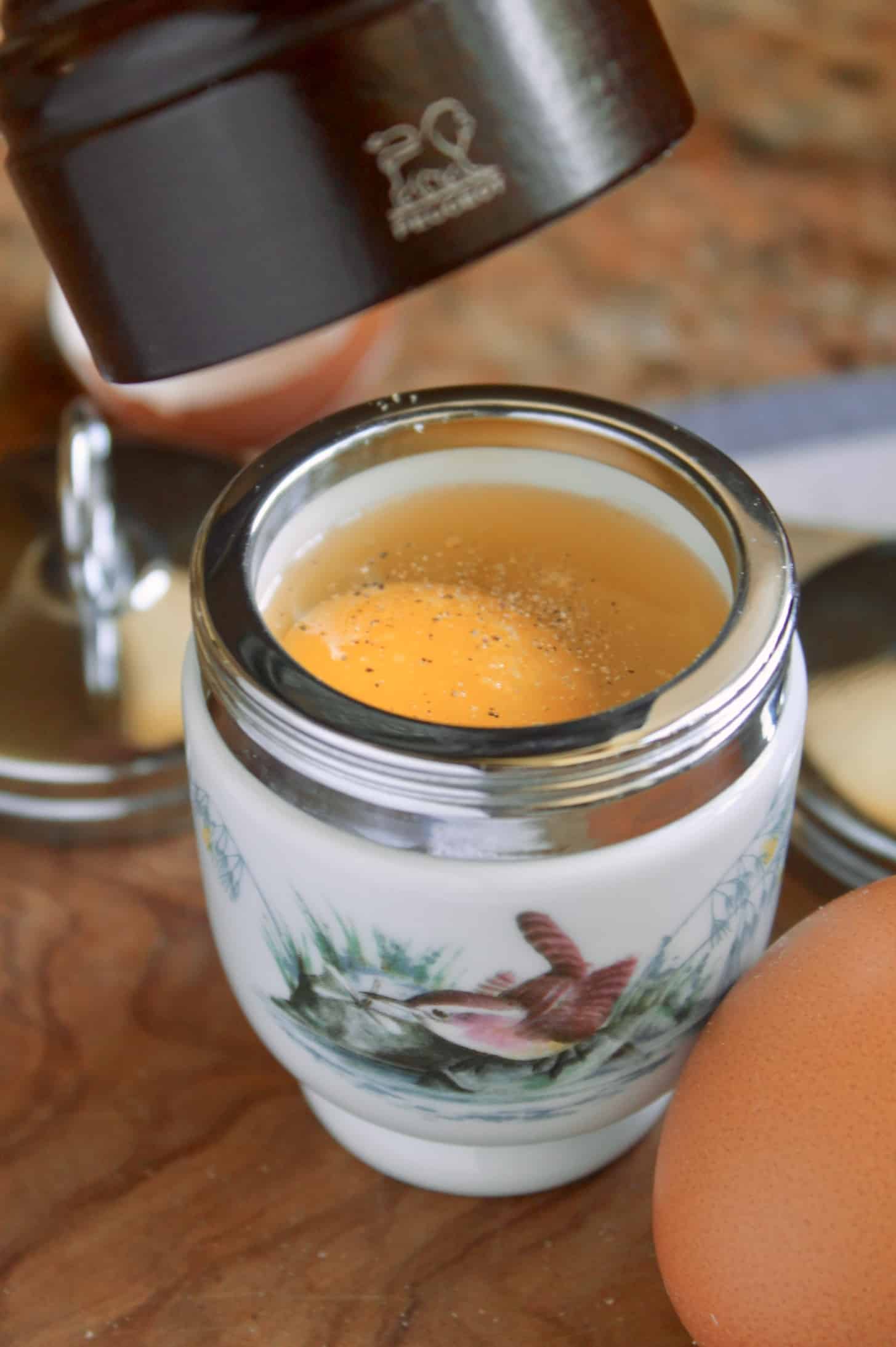 grinding pepper onto an egg