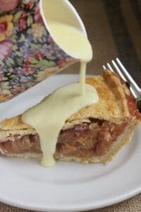 pouring custard on rhubarb pie