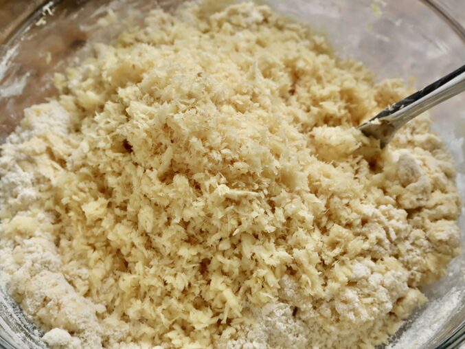 adding grated parsnip to bowl adding parsnip to the dough