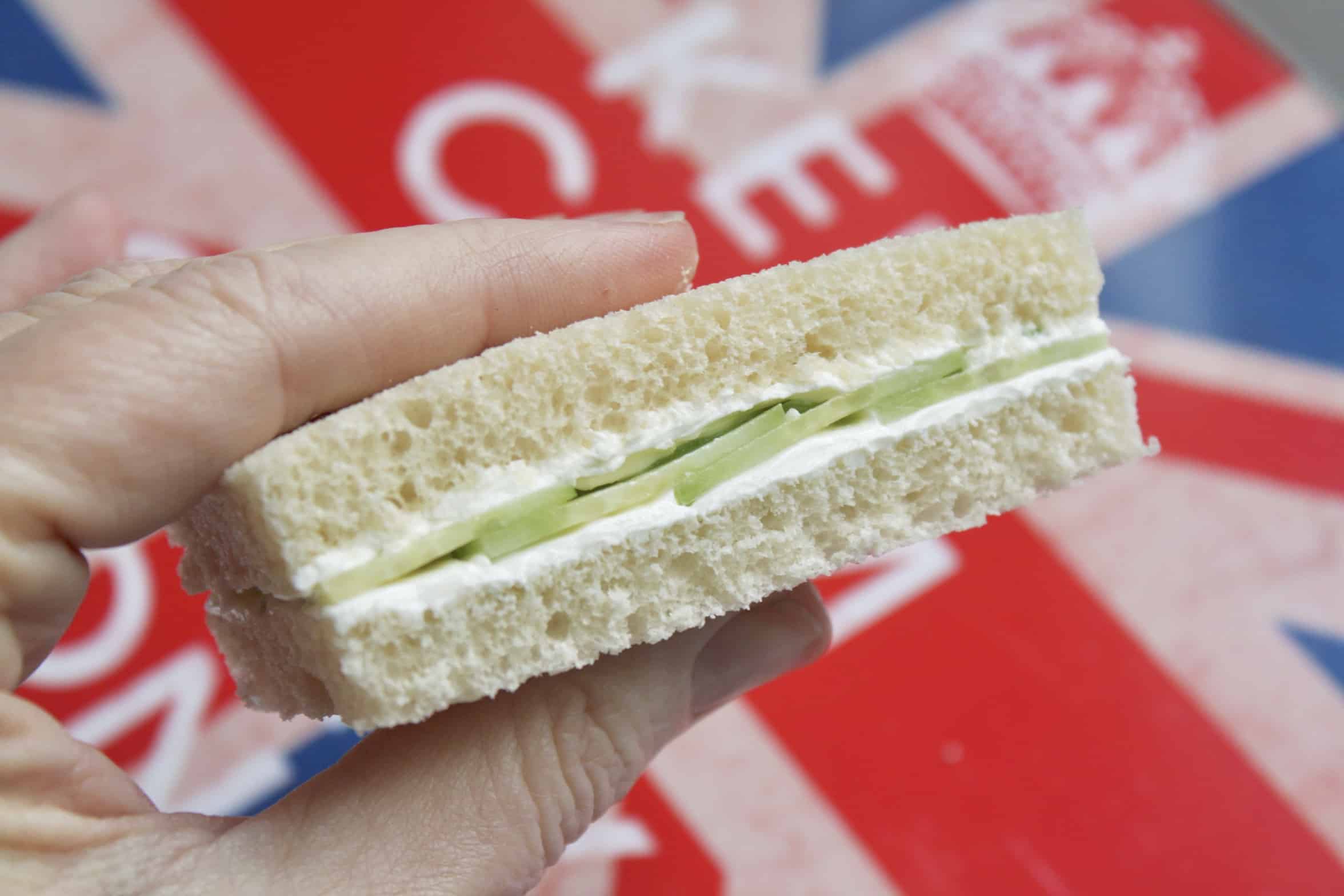 holding a cucumber sandwich