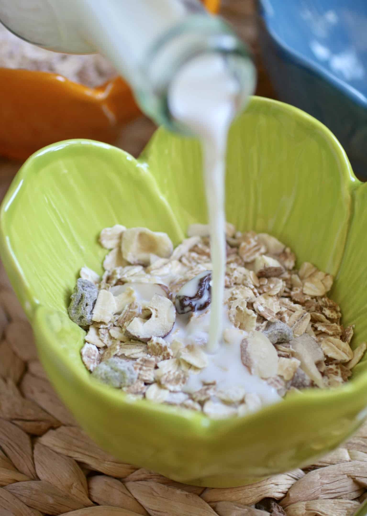 pouring milk into cereal pouring milk into cereal