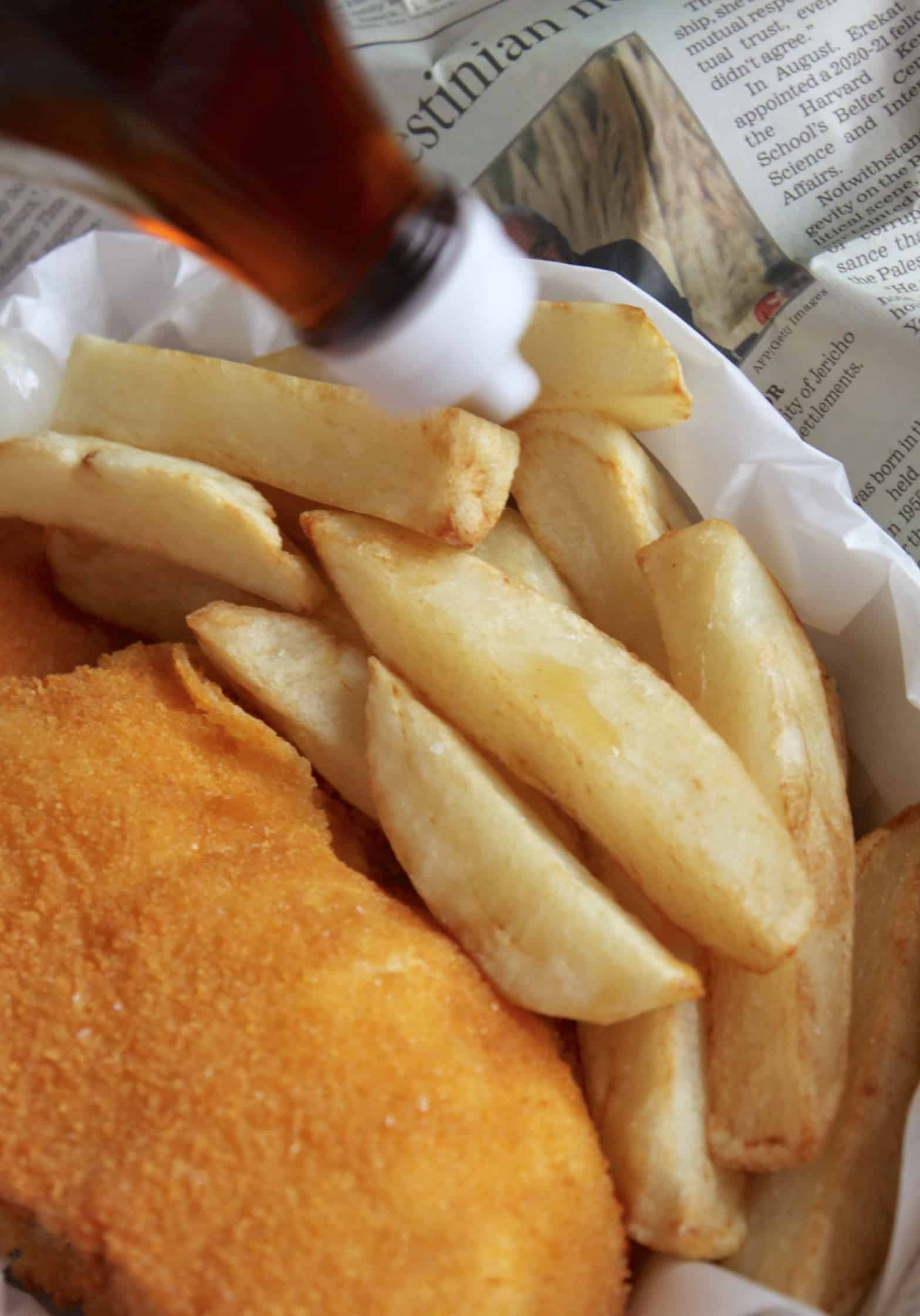 dousing fish and chips with vinegar