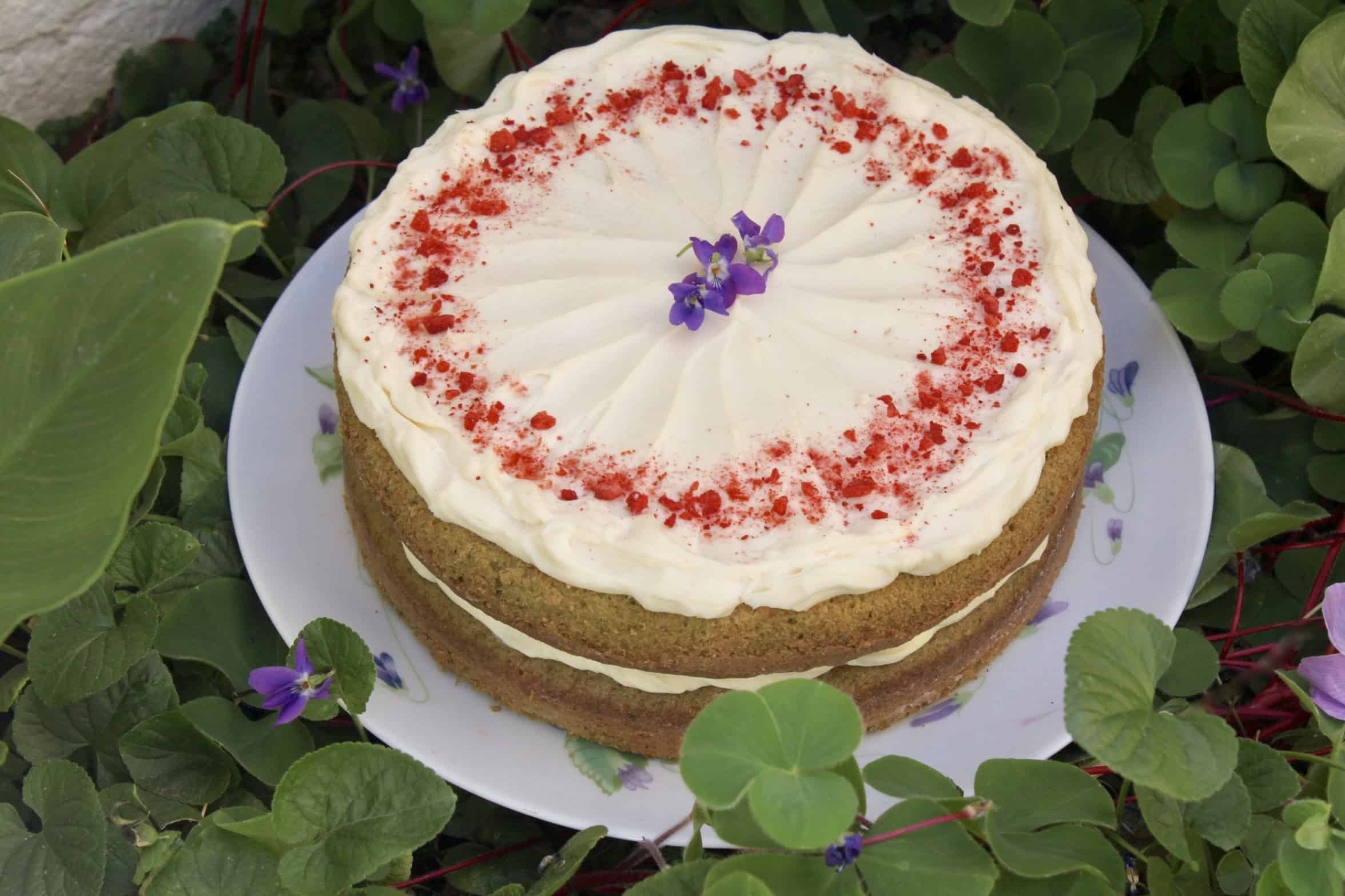 green cake in clover with flower