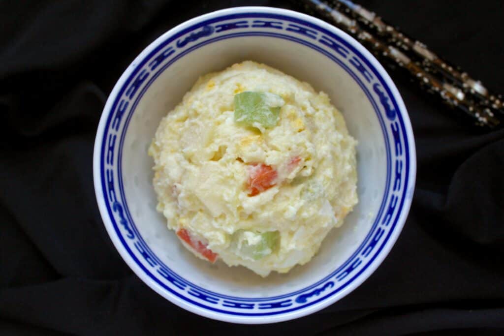 scoop of gamja salad in a bowl