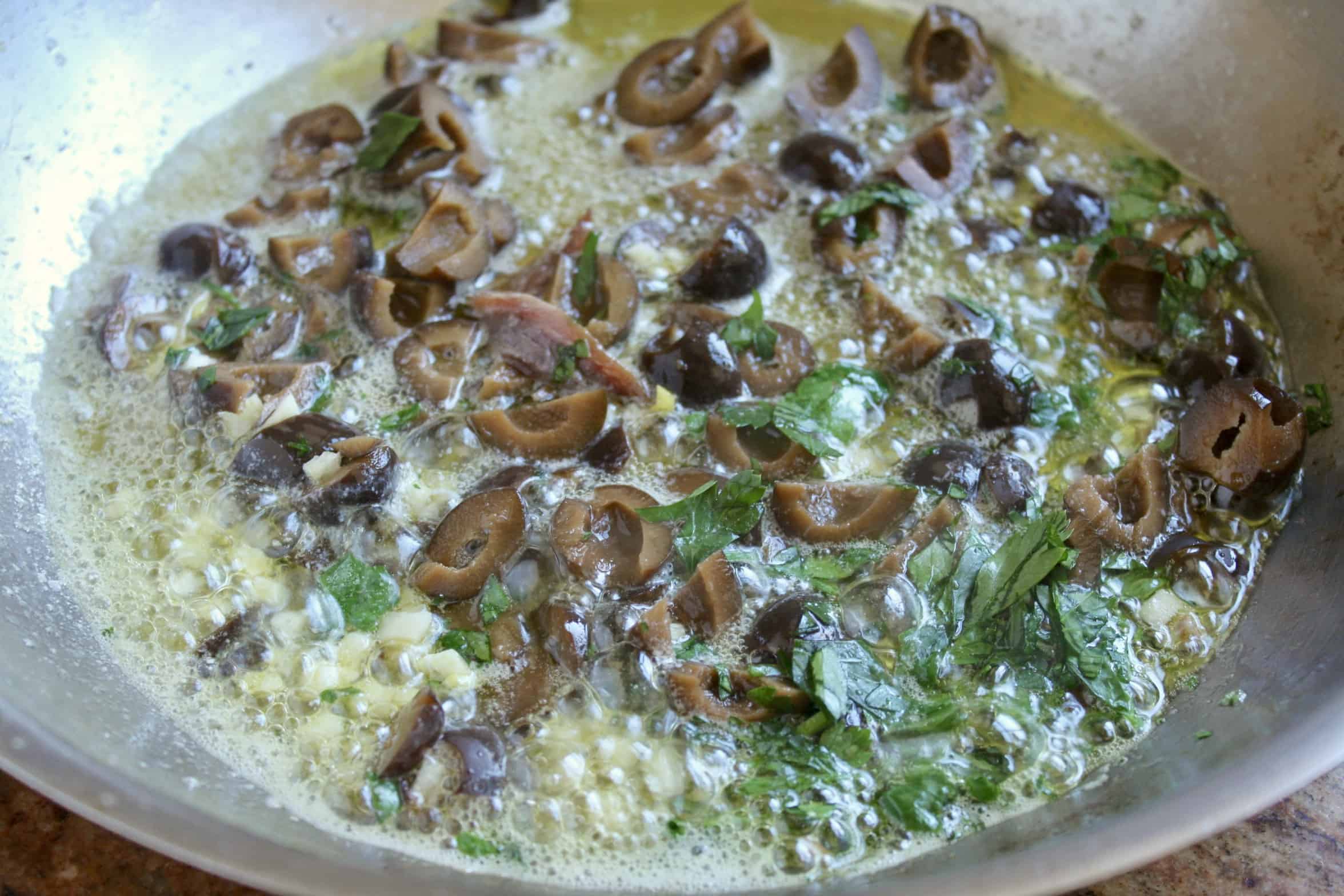 making sauce with the black olives and anchovy