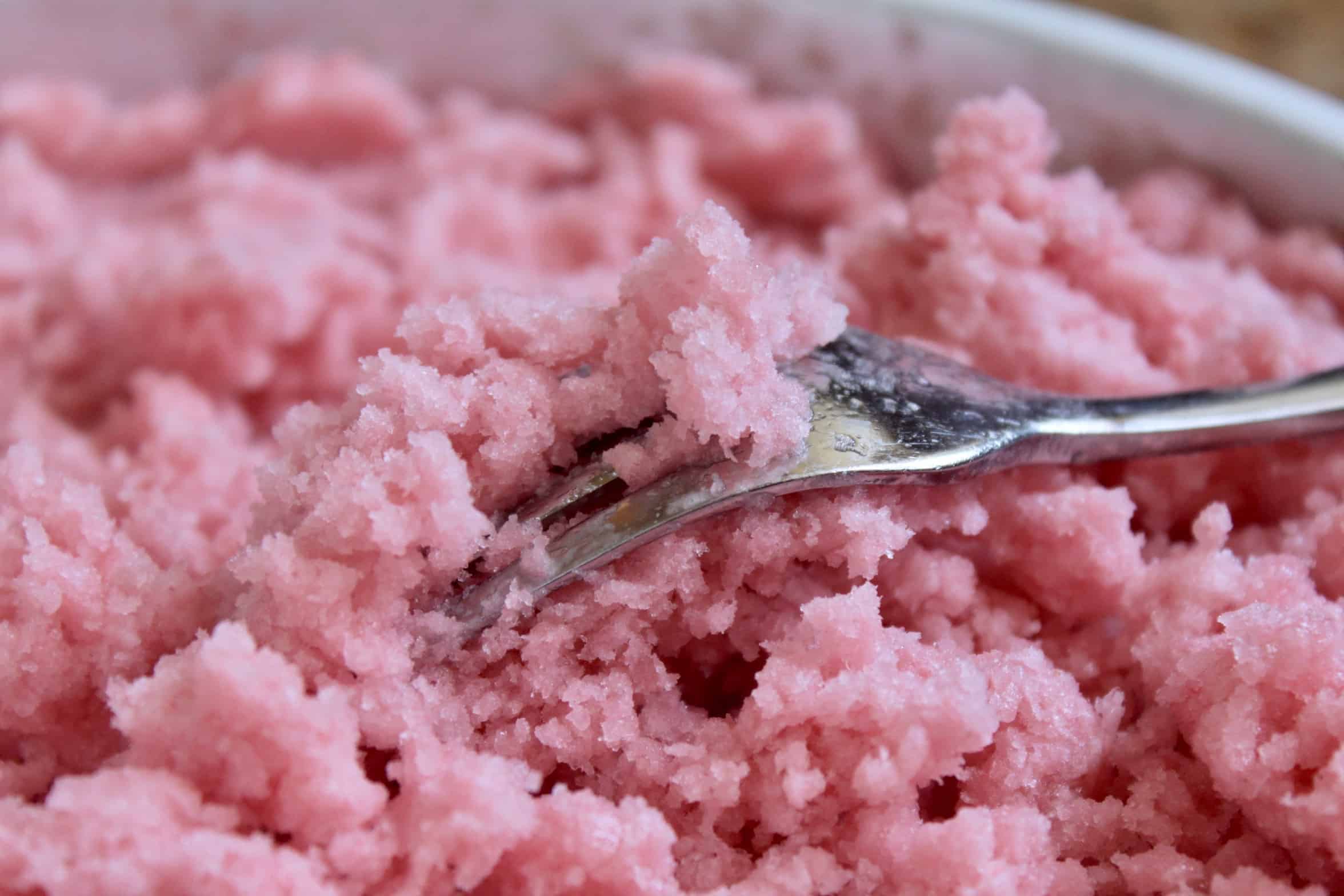 using a fork to stir the frozen dessert