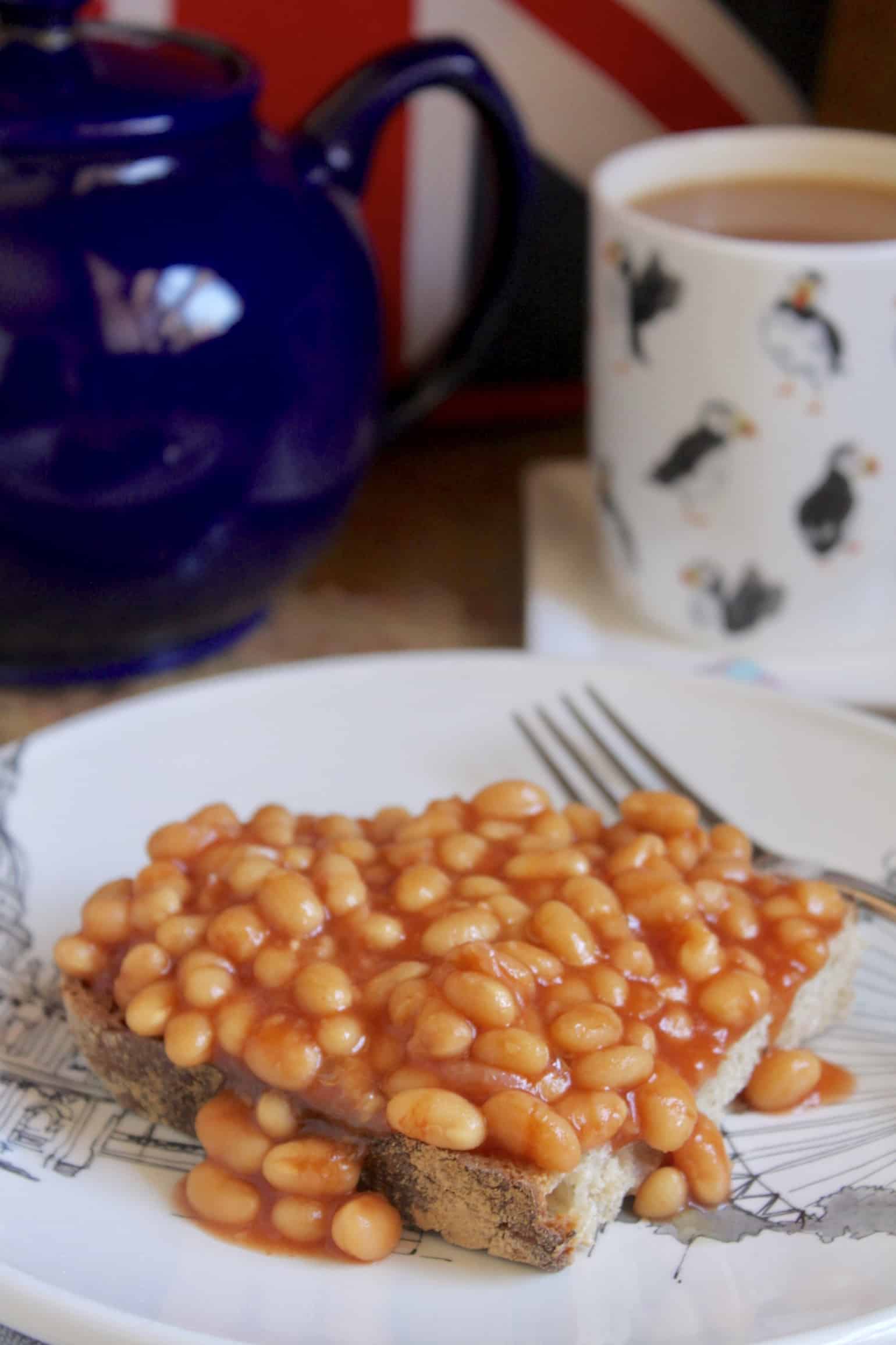 Beans on toast on a plate with tea