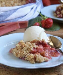 strawberry rhubarb crisp with ice cream on a blue plate
