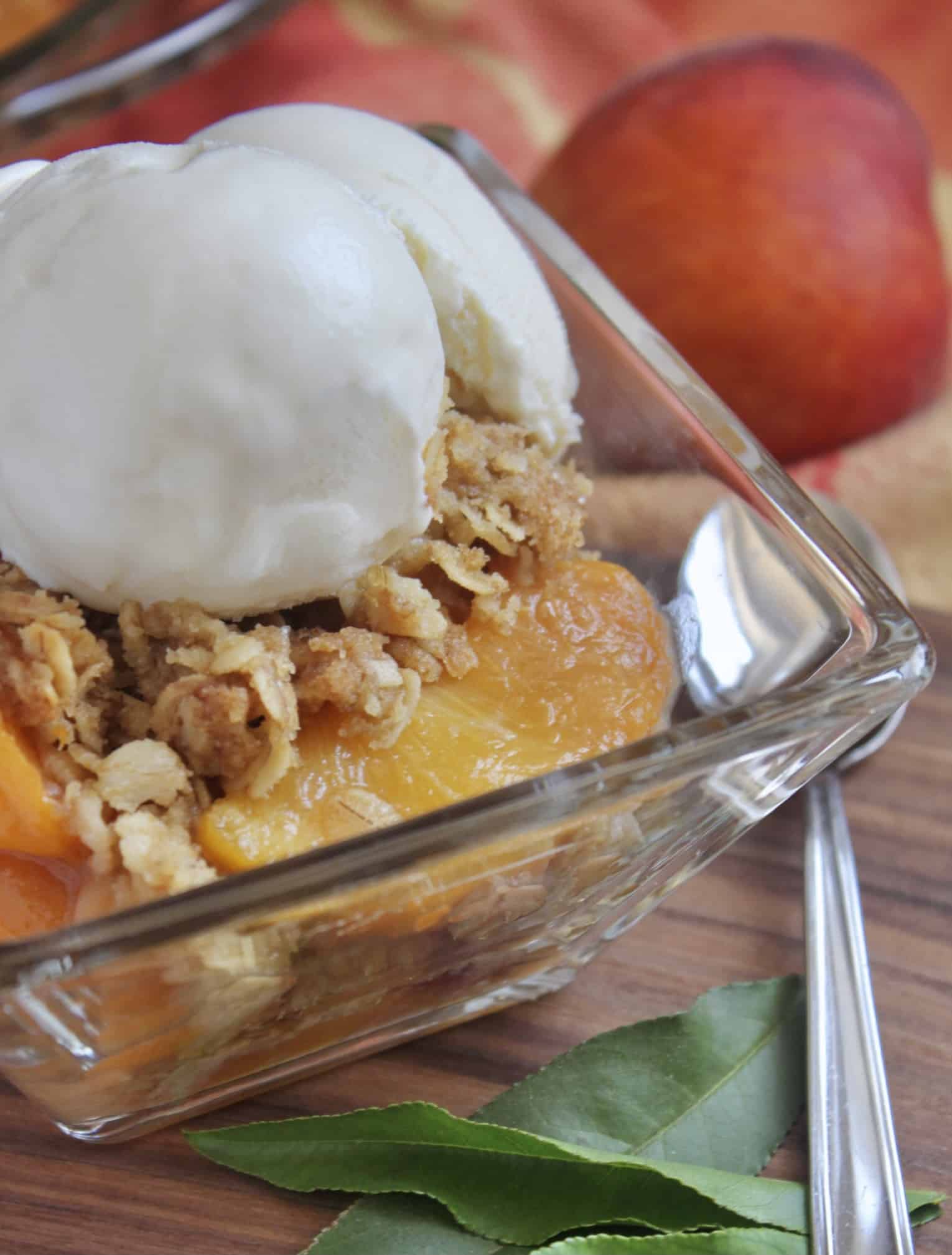 square glass bowl with peach dessert and ice cream