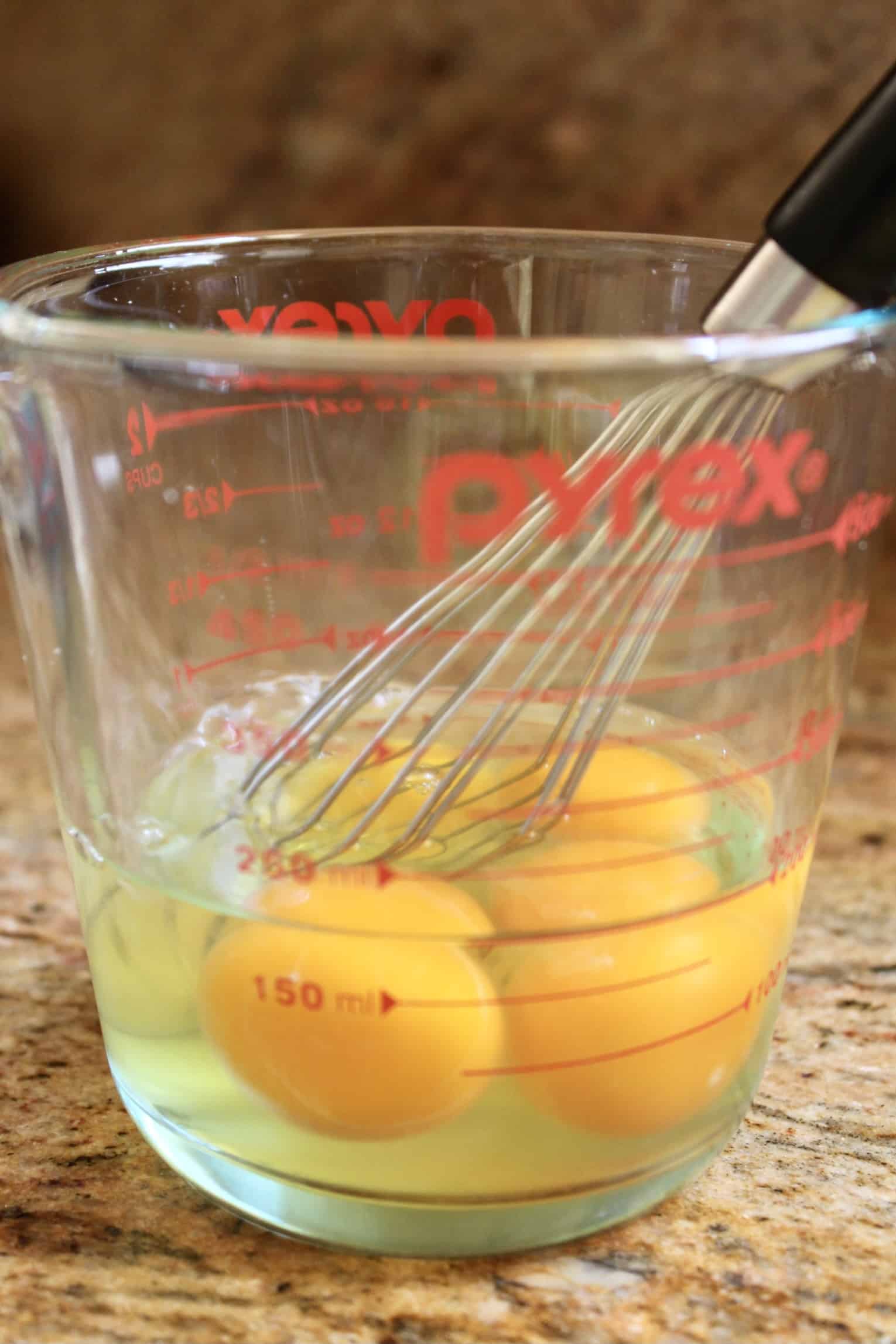 eggs in a jug with a whisk