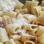 adding Parmigiano to the pancetta pasta
