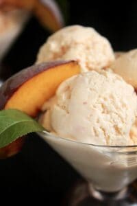 peach ice cream with a slice of peach