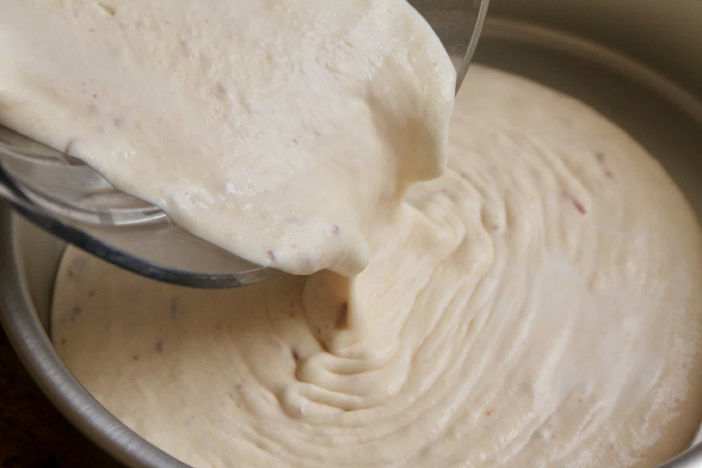 pouring peaches and cream into pan