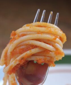 forkful of pasta with fresh tomato sauce