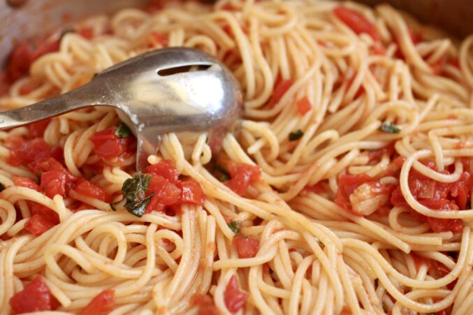 mixing in tomato sauce