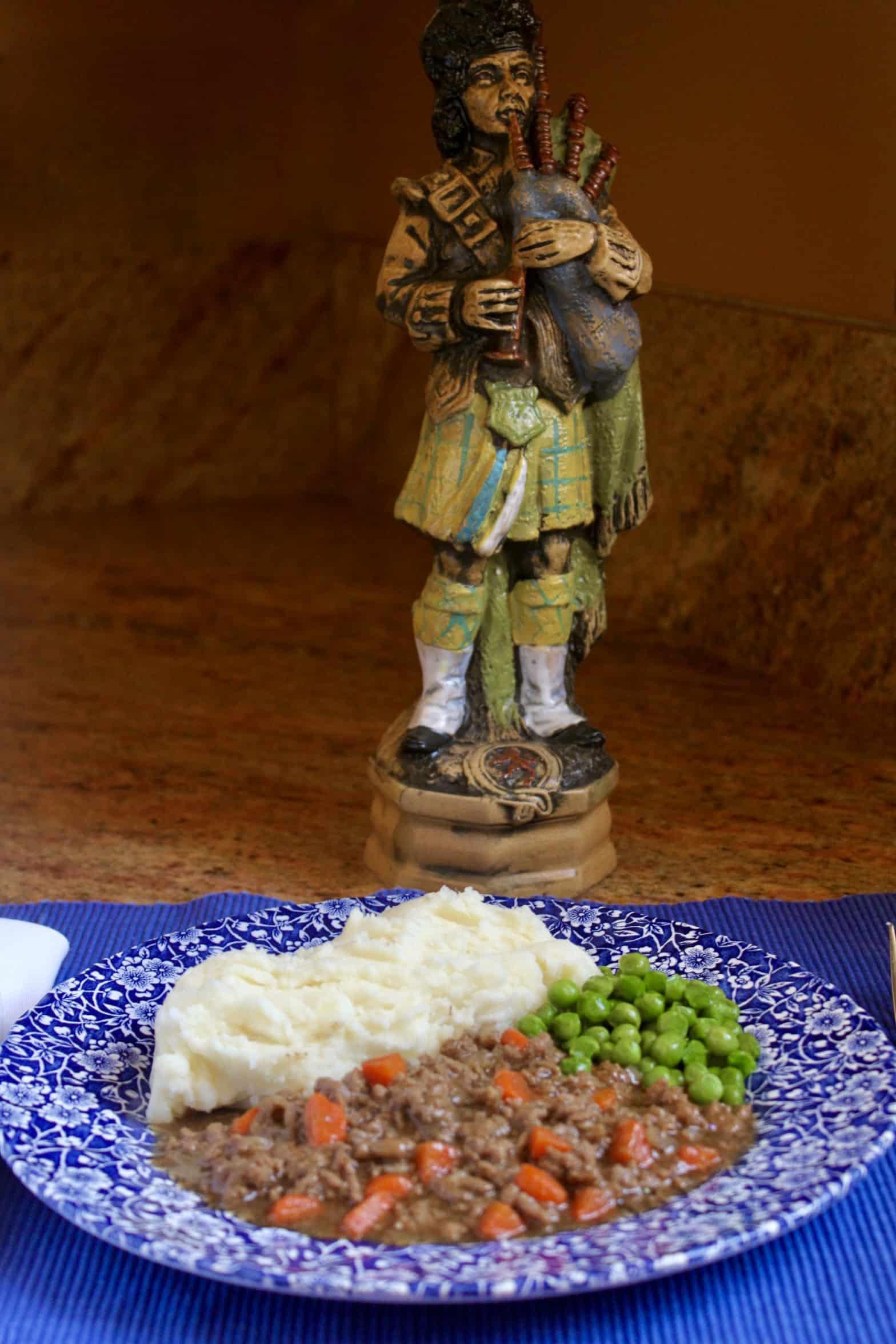 Mince and tatties with a piper in the background