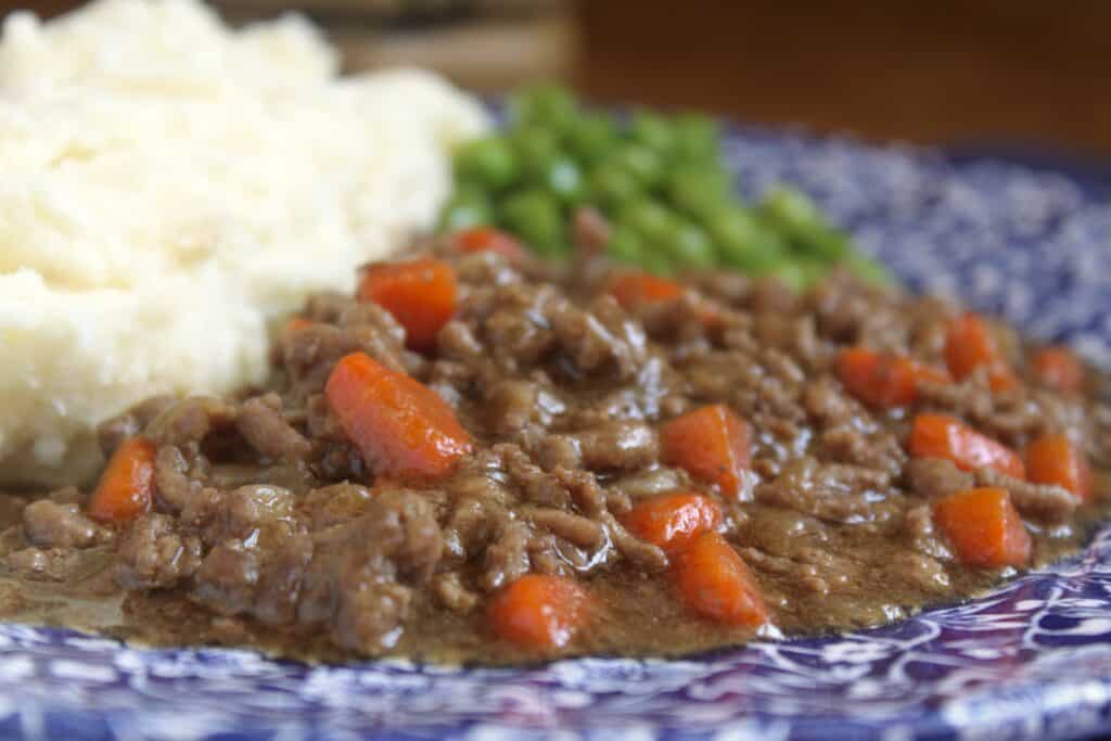 mince and tatties and peas on a floral plate