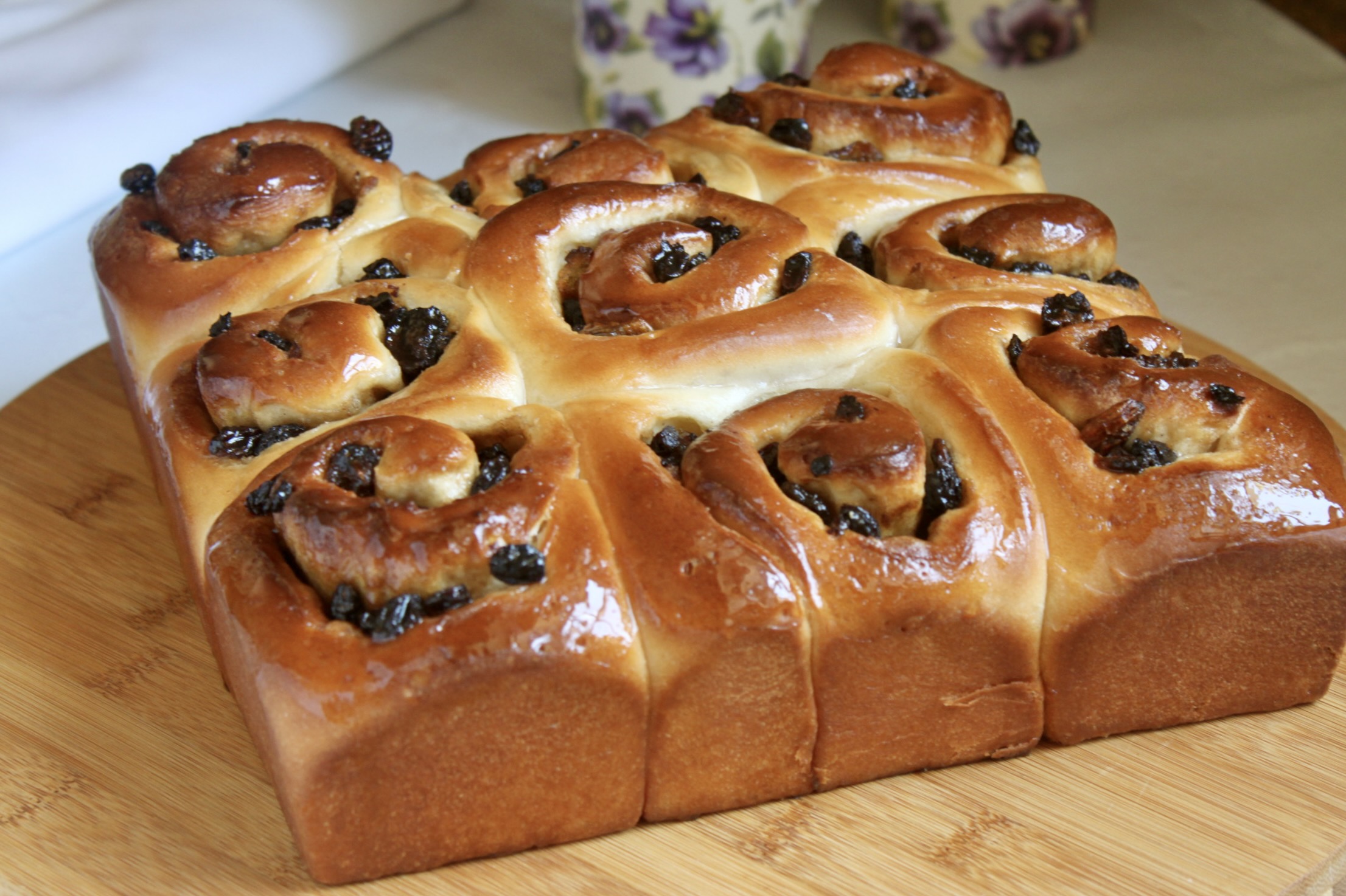 Chelsea buns on a wooden board.