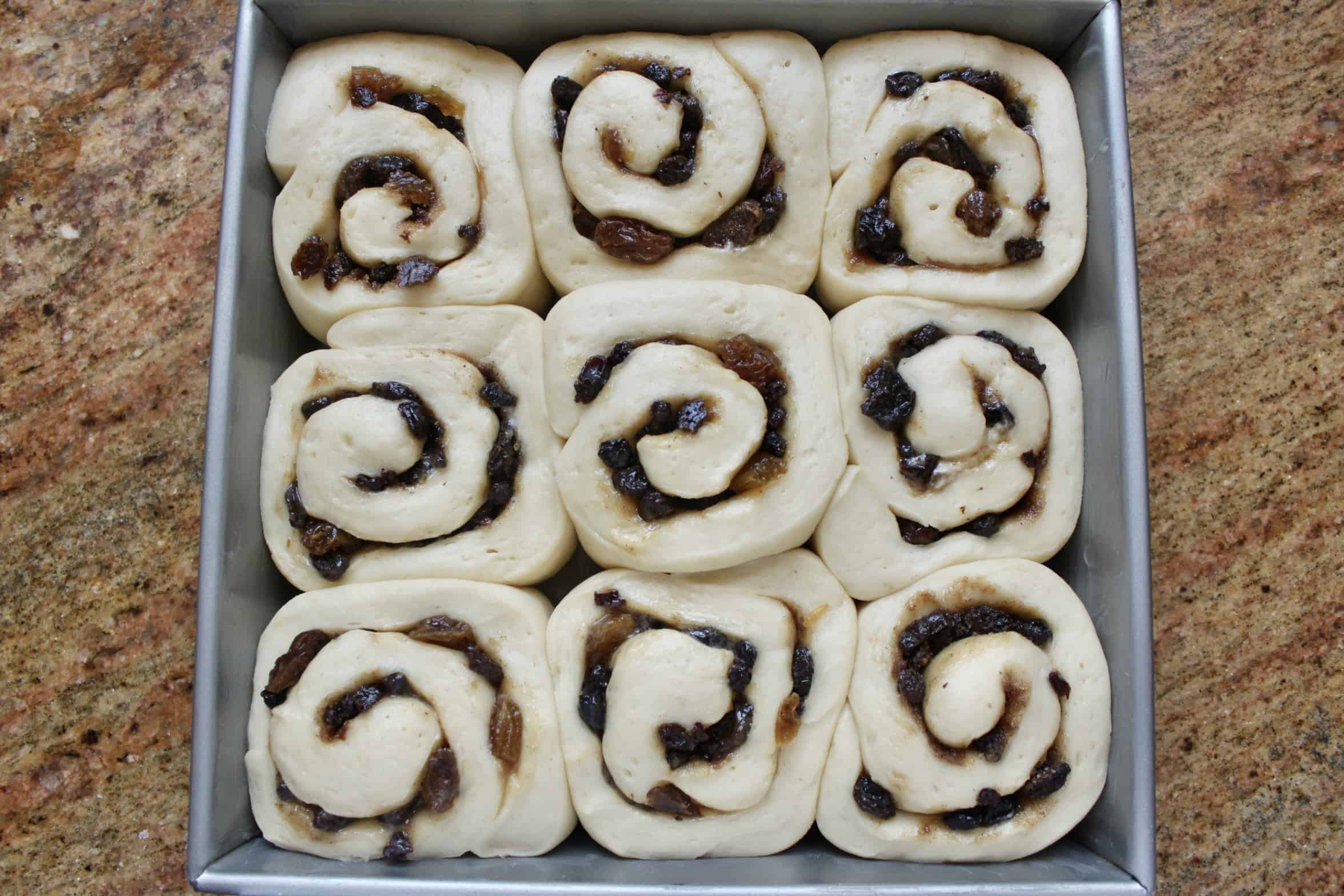 proofed buns in a pan