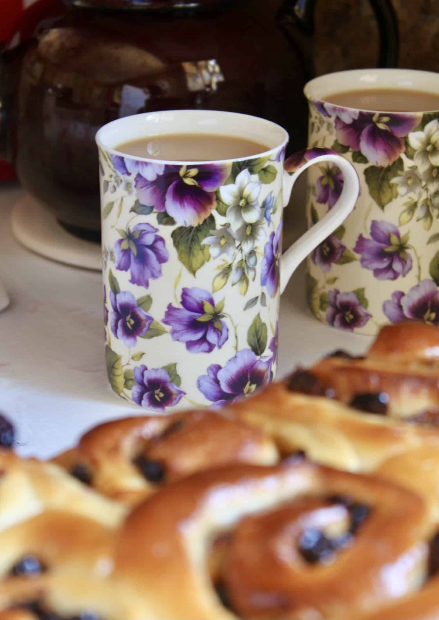 cup of tea with Chelsea buns in foreground