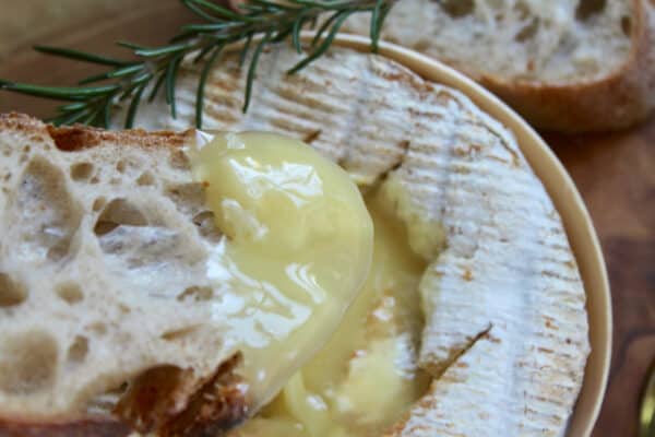 dipping bread into melted Camembert