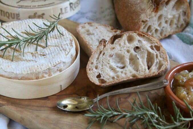 bread, cheese, spoon and rosemary sprigs