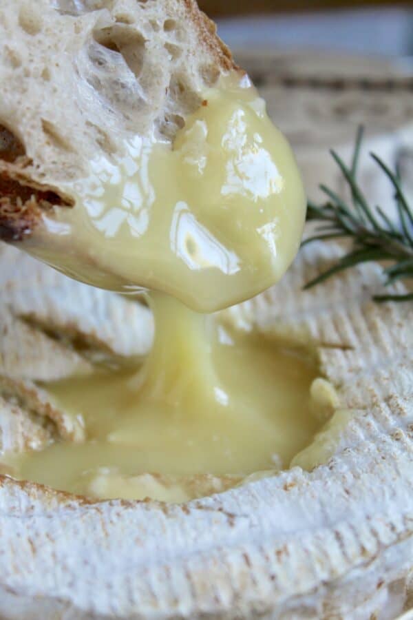 dipping bread into melted Camembert