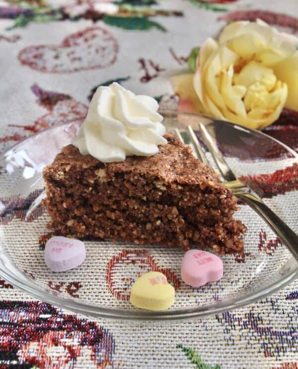 Hazelnut cake for Valentine's day with love hearts and a yellow rose.