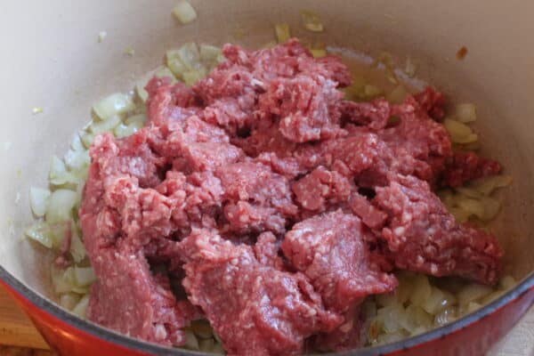 adding ground beef to the pot