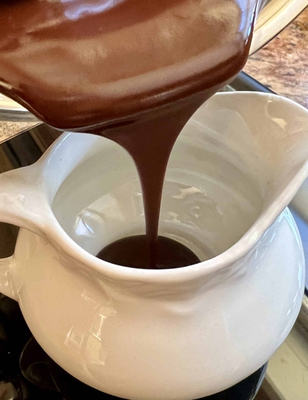 pouring chocolate sauce into a jug
