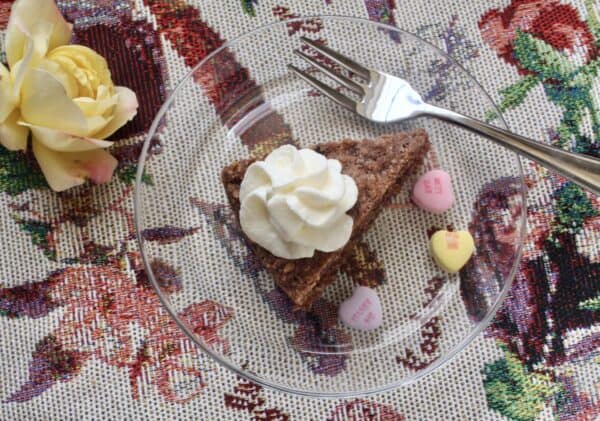 Hazelnut cake for Valentine's day with love hearts and a yellow rose.