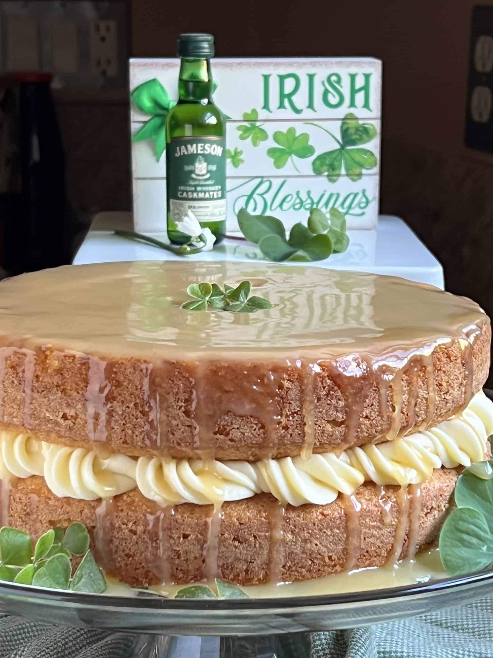 Irish blessings sign, Jameson's whiskey bottle and whiskey cake on plate