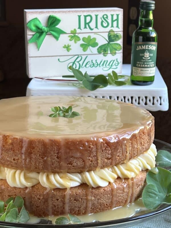 Irish blessings sign, Jameson's whiskey bottle and whiskey cake on plate