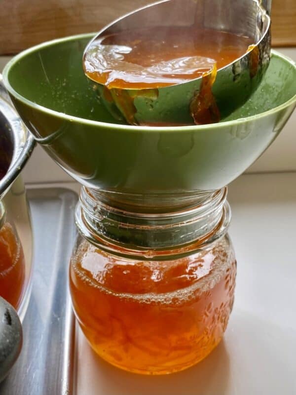 ladling marmalade into jars